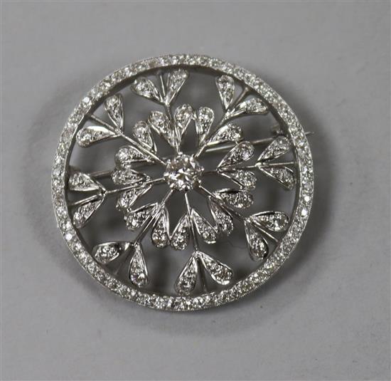 A white metal and diamond set open work circular brooch, 35mm.